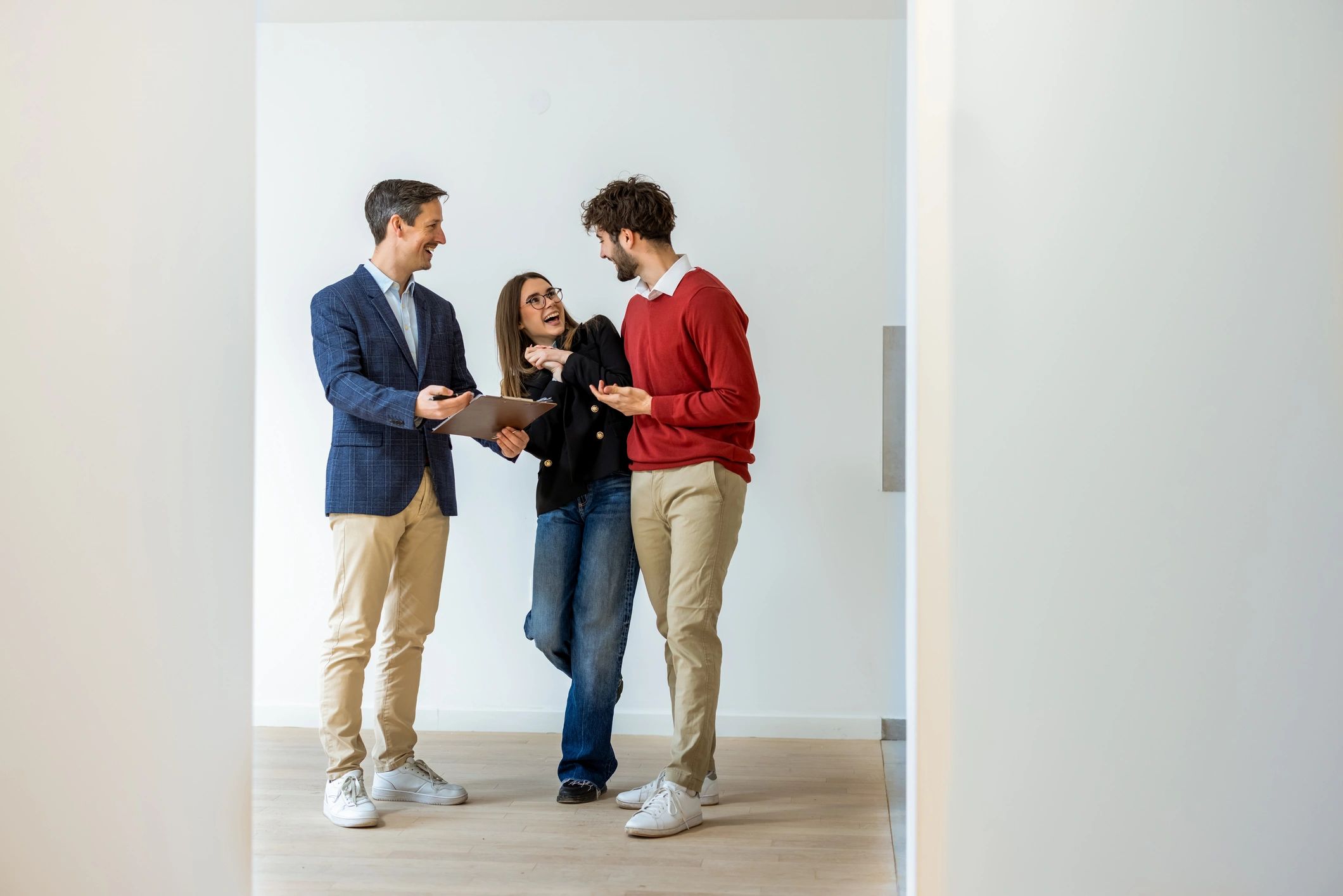 Couple celebrating a successful home purchase in a bright new apartment